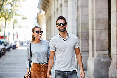 Buy stock photo Shot of an affectionate young couple exploring a foreign city