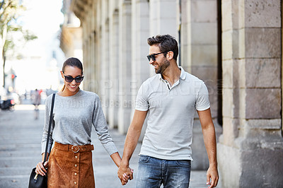 Buy stock photo Shot of an affectionate young couple exploring a foreign city