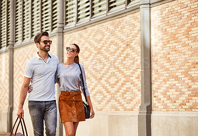 Buy stock photo Shot of an affectionate young couple exploring a foreign city