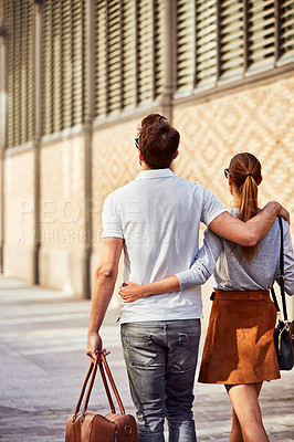 Buy stock photo Shot of an affectionate young couple exploring a foreign city