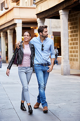 Buy stock photo Shot of an affectionate young couple exploring a foreign city