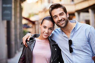 Buy stock photo Shot of an affectionate young couple exploring a foreign city