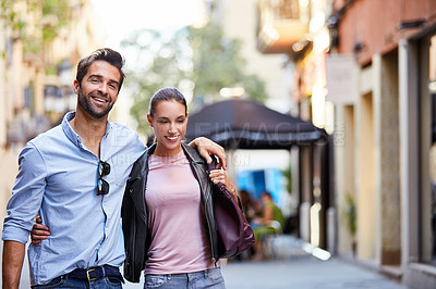 Buy stock photo Shot of an affectionate young couple exploring a foreign city