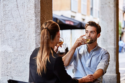 Buy stock photo Shot of a couple having wine outside at a restaurant