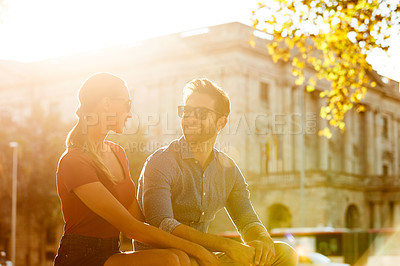 Buy stock photo Shot of a loving couple out in the city on a sunny day