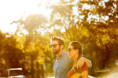Buy stock photo Shot of a loving couple out in the city on a sunny day