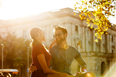 Buy stock photo Shot of a loving couple out in the city on a sunny day