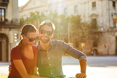 Buy stock photo Shot of a loving couple out in the city on a sunny day