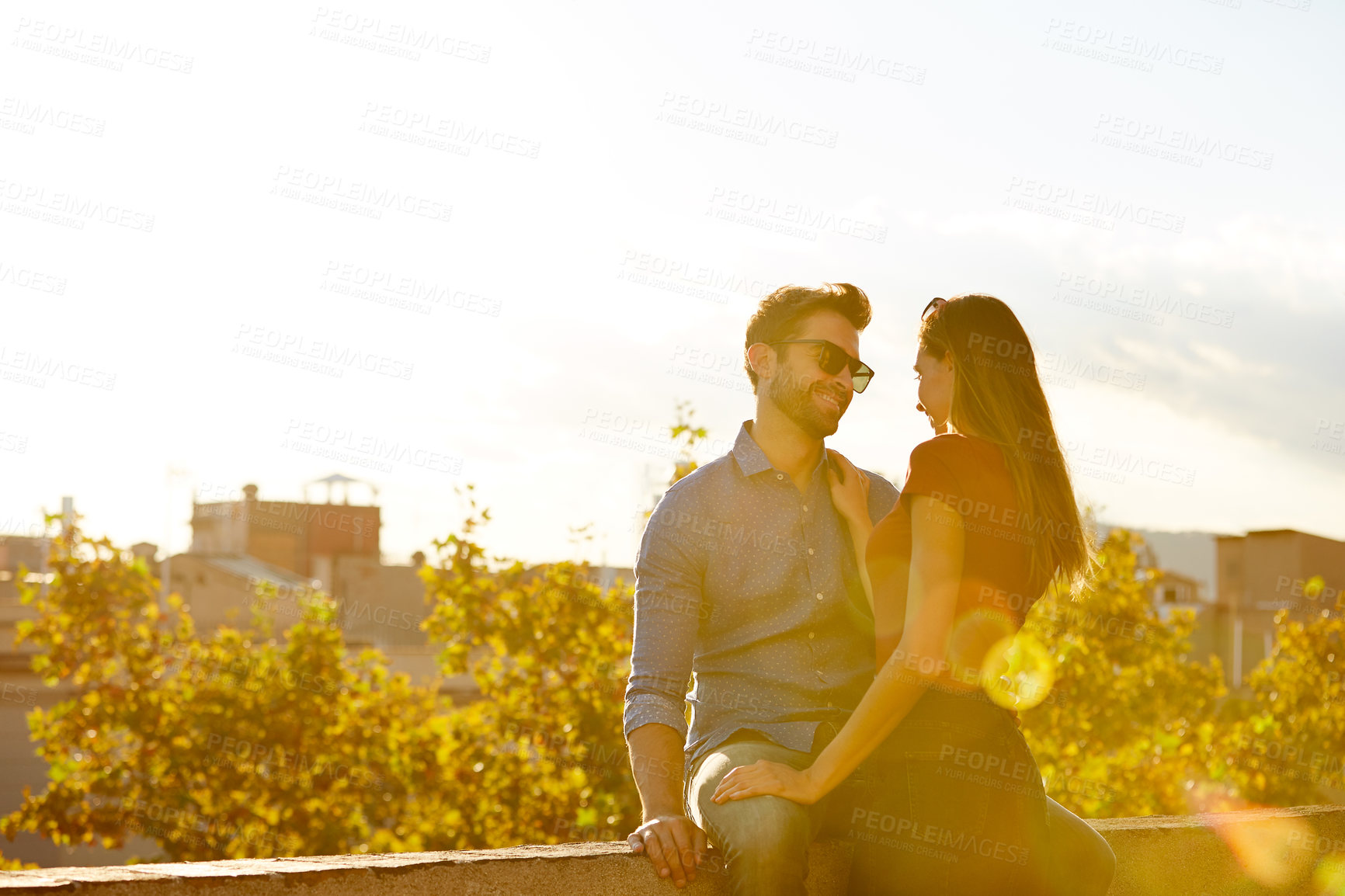 Buy stock photo Shot of a couple out on a rooftop for their date