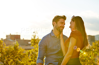 Buy stock photo Shot of a couple out on a rooftop for their date