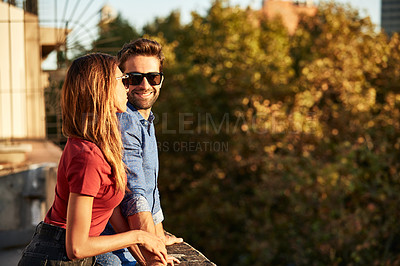 Buy stock photo Shot of an affectionate young couple exploring a foreign city