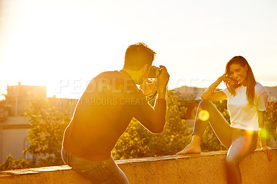 Buy stock photo Shot of a couple taking pictures while out on a date