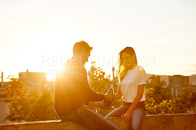 Buy stock photo Shot of a couple having champagne while on a rooftop date