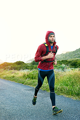 Buy stock photo Full length shot of a handsome young male athlete out for a morning run