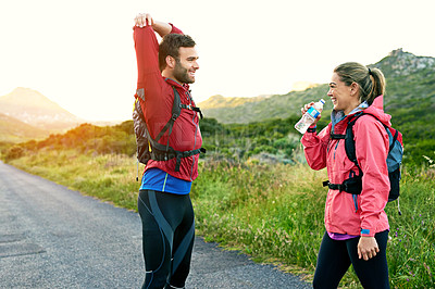 Buy stock photo Cropped shot of a young couple warming up before their morning run