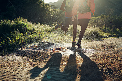 Buy stock photo Rearview shot of an unrecognizable young couple out for a morning run