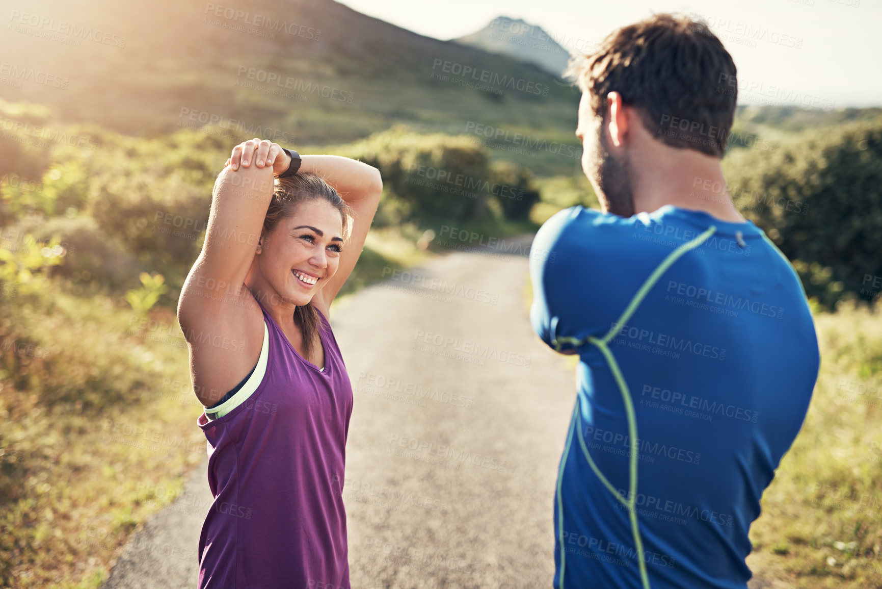 Buy stock photo Cropped shot of a young couple warming up before their morning run
