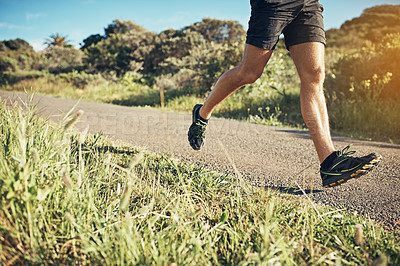 Buy stock photo Cropped shot of an unrecognizable young man out for his morning run