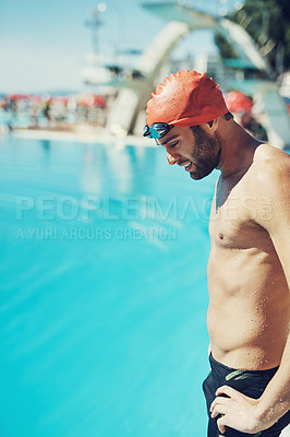 Buy stock photo Cropped shot of a handsome young male swimmer standing with his hands on his hips by the pool