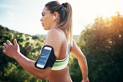 Buy stock photo Cropped shot of an attractive young female athlete out for a morning run