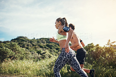 Buy stock photo Cropped shot of a young couple out for their morning run