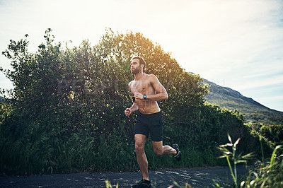 Buy stock photo Full length shot of a handsome young male athlete out for a morning run