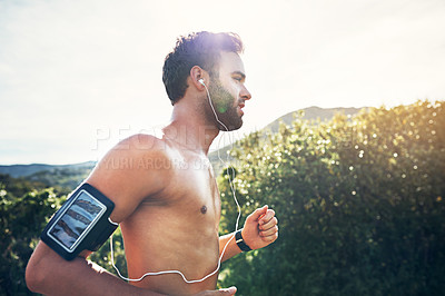 Buy stock photo Cropped shot of a handsome young male athlete out for a morning run