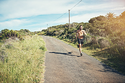 Buy stock photo Full length shot of a handsome young male athlete out for a morning run