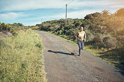 Buy stock photo High angle shot of an attractive young female athlete out for a morning run