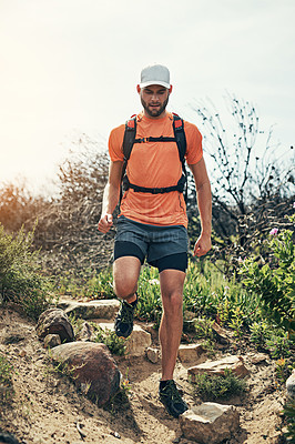 Buy stock photo Low angle shot of a handsome young male athlete out for a morning run