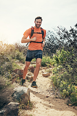 Buy stock photo Low angle shot of a handsome young male athlete out for a morning run