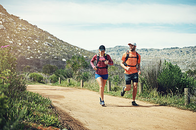 Buy stock photo Rearview shot of a young athletic couple out for their morning run