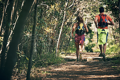 Buy stock photo Rearview shot of a young athletic couple out for their morning run