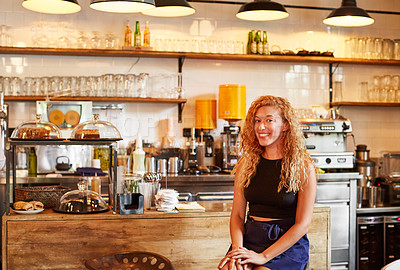 Buy stock photo Shot of a female barista on duty in a coffee shop
