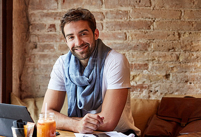 Buy stock photo Cropped shot of a handsome young man sitting in a coffee shop
