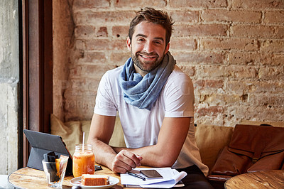 Buy stock photo Cropped shot of a handsome young man sitting in a coffee shop