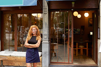 Buy stock photo Shot of a young woman standing in front of her coffee shop