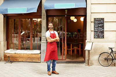 Buy stock photo Shot of a young man standing in front of his coffee shop