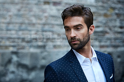 Buy stock photo Cropped shot of a handsome young businessman standing in an urban alleyway