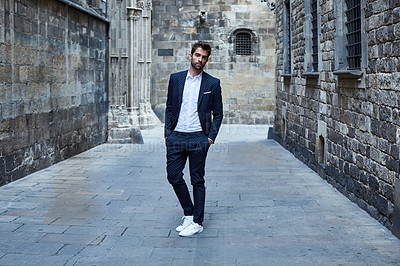 Buy stock photo Full length portrait of a handsome young businessman standing in an urban alleyway