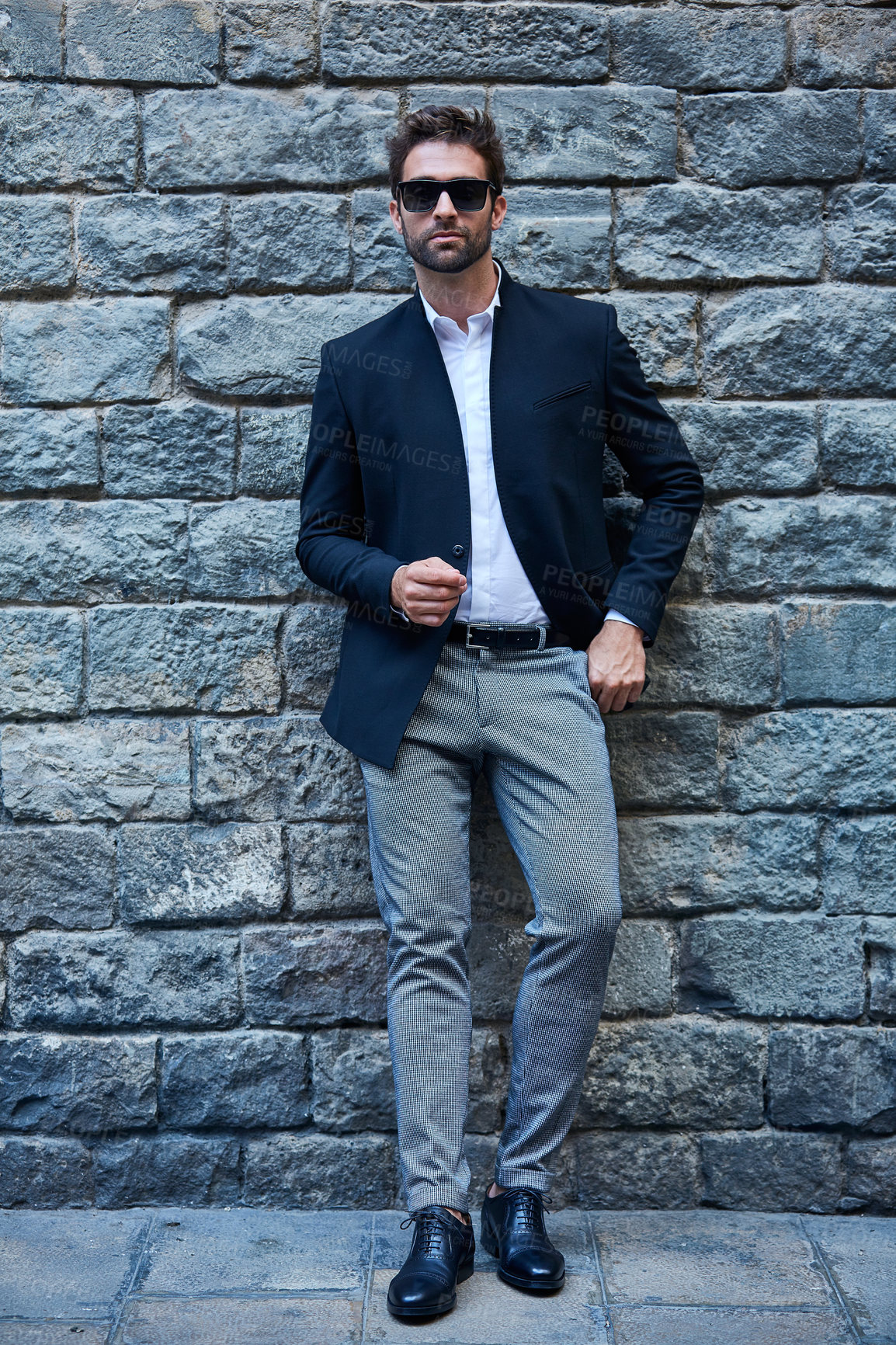 Buy stock photo Fashion, sunglasses and business man in city with corporate style, confidence or cool clothes. Formal suit, shades or male person with executive attire, bespoke or professional menswear on brick wall