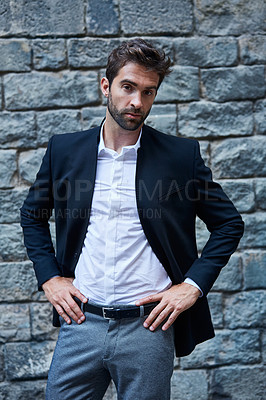 Buy stock photo Cropped portrait of a handsome young businessman standing against a brick wall in an urban alleyway