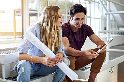 Buy stock photo Shot of a focused young couple drawing plans and choosing colors for the renovation of their house