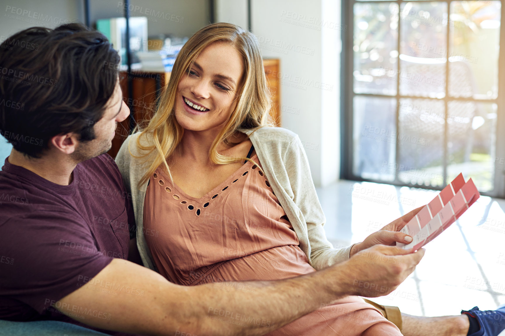 Buy stock photo Pregnancy, couple and swatches in home for renovation planning, nursery decoration or color choice. People, future parents and happy with palette, house upgrade and paint talk for nesting preparation