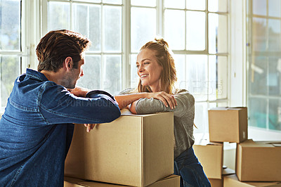 Buy stock photo Shot of a young couple moving into their new home