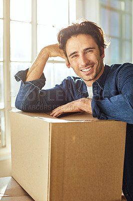 Buy stock photo Shot of a young man moving into his new home
