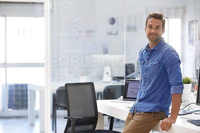 Buy stock photo Shot of a confident young man in his office