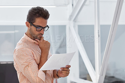 Buy stock photo Shot of a young businessman working in his office