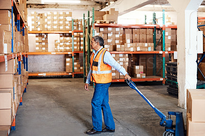 Buy stock photo Shot of a mature man moving boxes in a warehouse