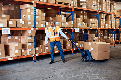 Buy stock photo Shot of a mature man doing moving boxes in a warehouse